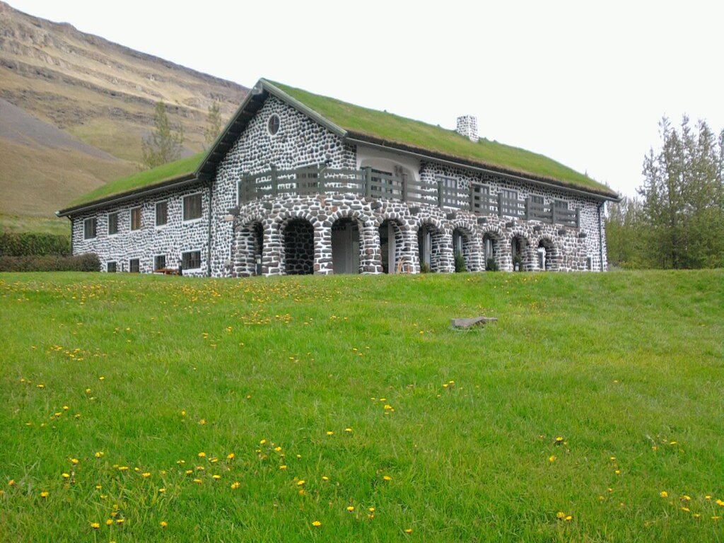 a white plate topped with a salad covered in shrimp